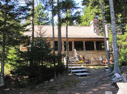 Real Estate Listing - 3 bedroom, 2 bath log cabin. Stone fireplace, screened porch, underground power, tranquil views of Southeast Harbor