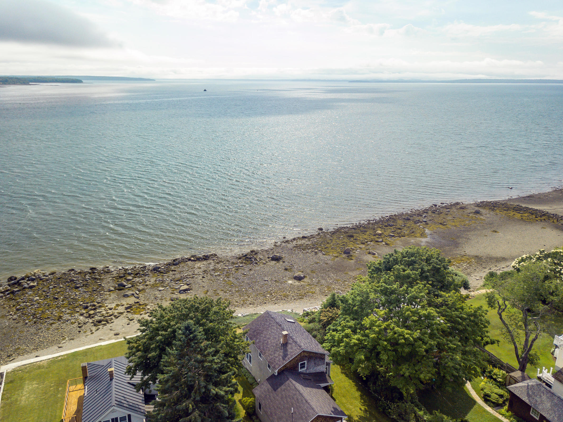 charming in-town, oceanfront home in one of Belfast's most desirable neighborhoods is sited at the waters edge and 
offers unparalleled views of Penobscot Bay from nearly every room