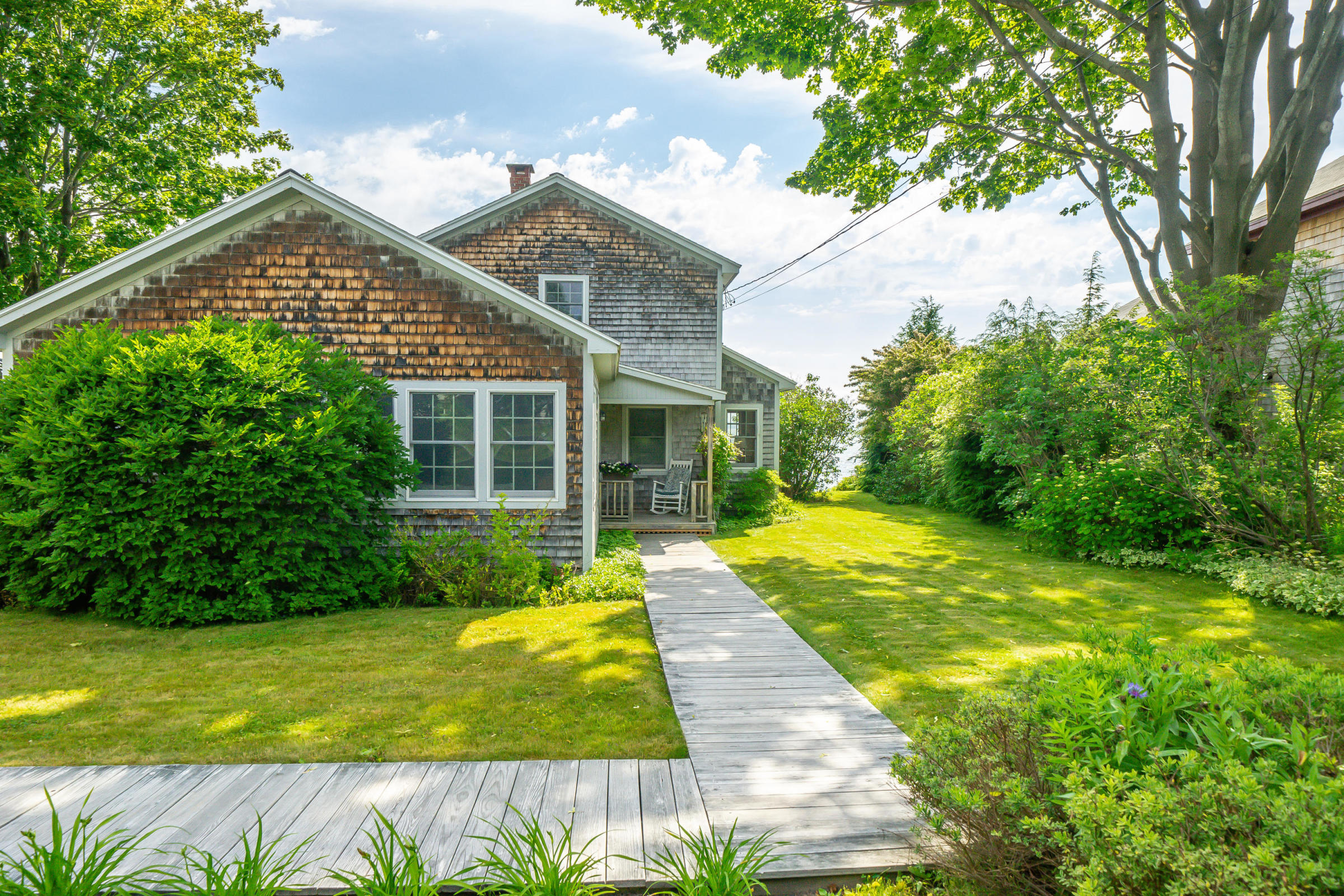 Maine Waterfront Home For Sale features light, bright open floor plan and walls of ocean-facing windows that showcase the Harbor and Penobscot Bay 