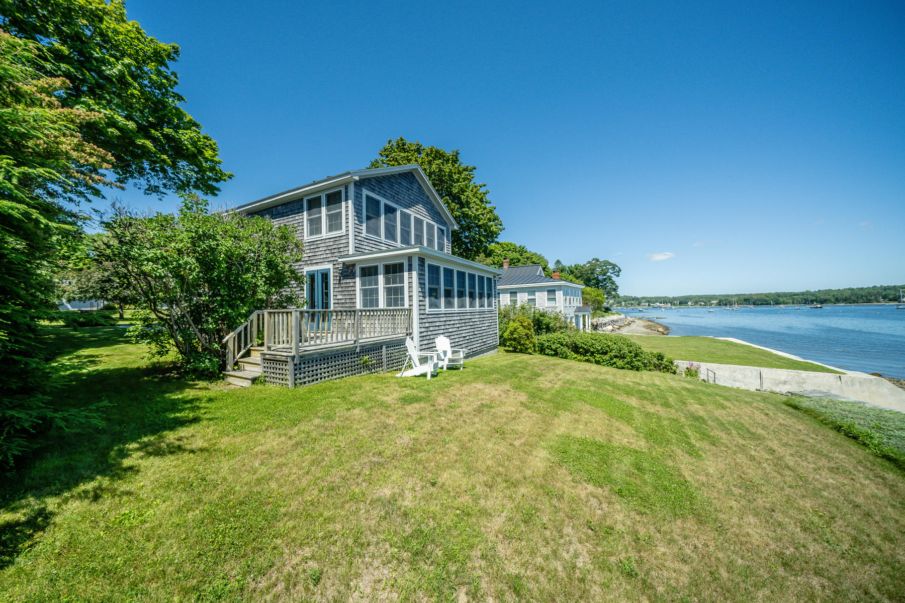 Waterfront home in Belfast Maine has beautiful flowering bushes and perennial plantings that add to the beauty of this year-round coastal haven 