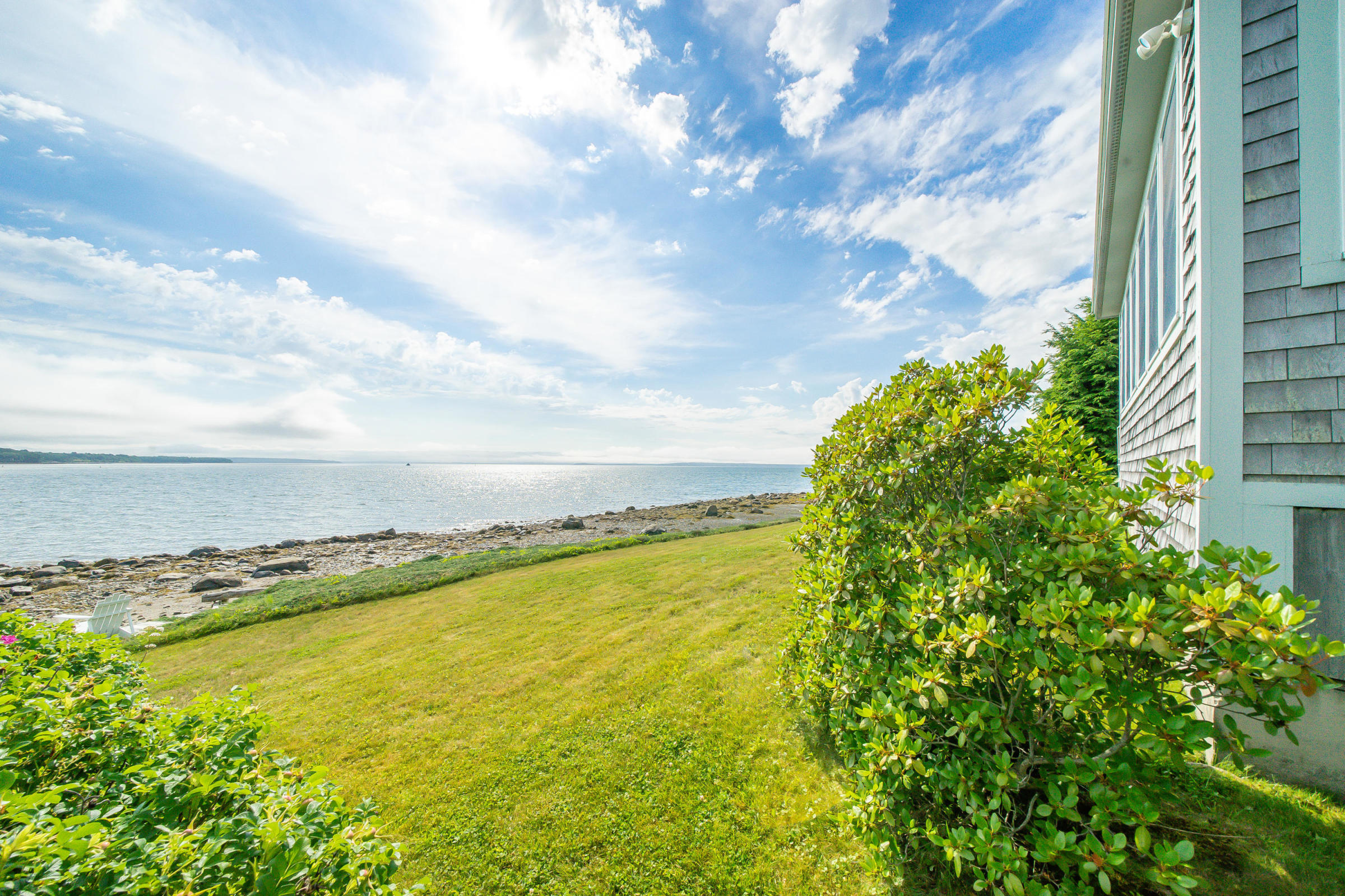 Maine Oceanfront with Penobscot Bay Ocean Views stands out with many amenities including a porch, a deck, a 1-car garage and steps to the shore