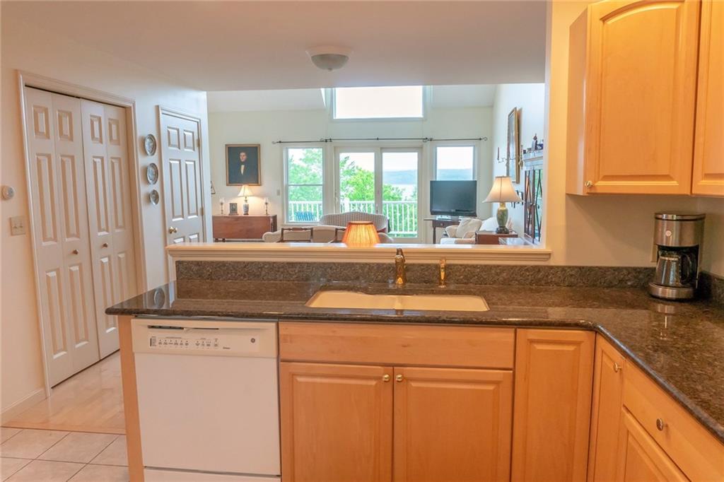 Stockton Springs Waterfront Condo for sale vaulted ceiling, gas fireplace, granite counters, hardwood floors, one-car, attached garage and two, spacious waterside decks for absolutely smashing sunsets
