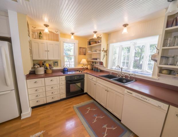 Kitchen well-appointed kitchen with cherry cupboards, a large island and granite counters